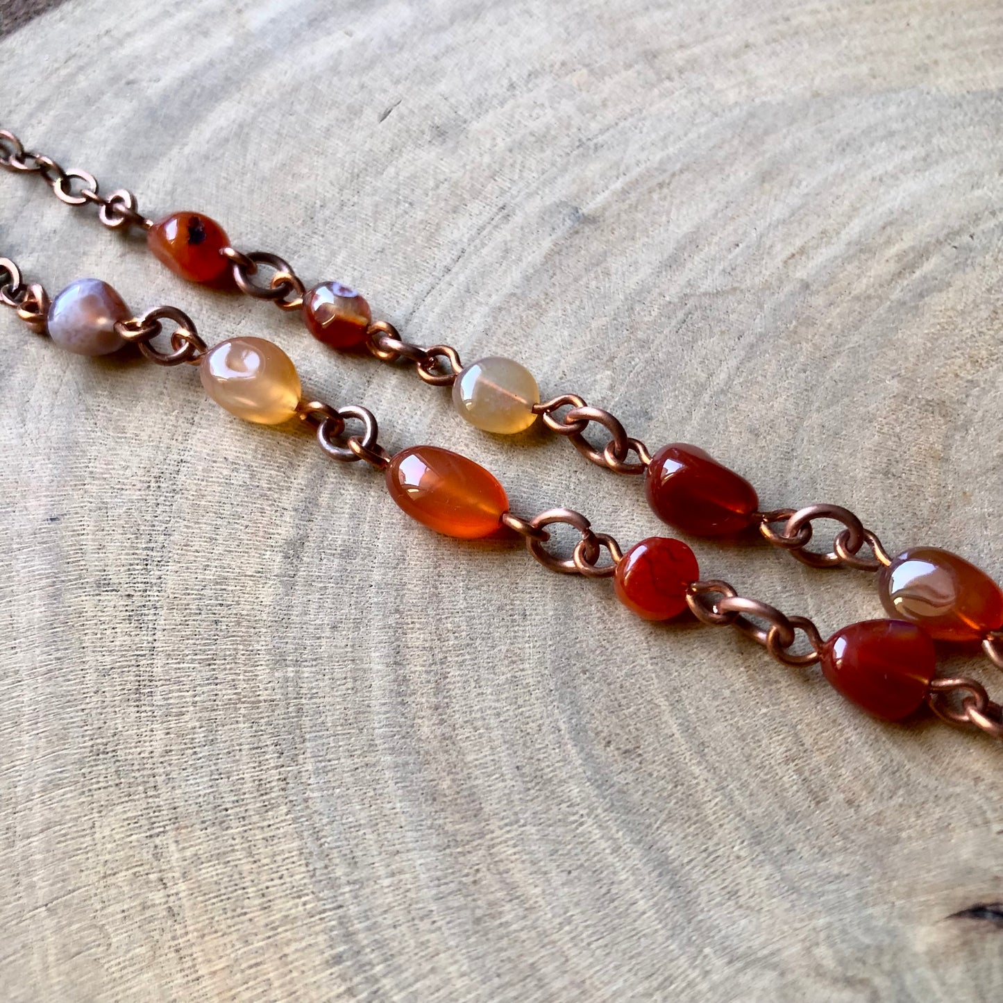 LAPIS LAZULI ON PIGEON FEATHER & CARNELIAN