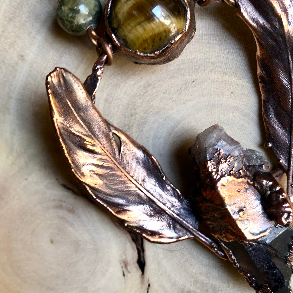 ST. CATHERINE’S SMOKY QUARTZ, TIGER EYE, GREEN GARNET & PIGEON FEATHERS