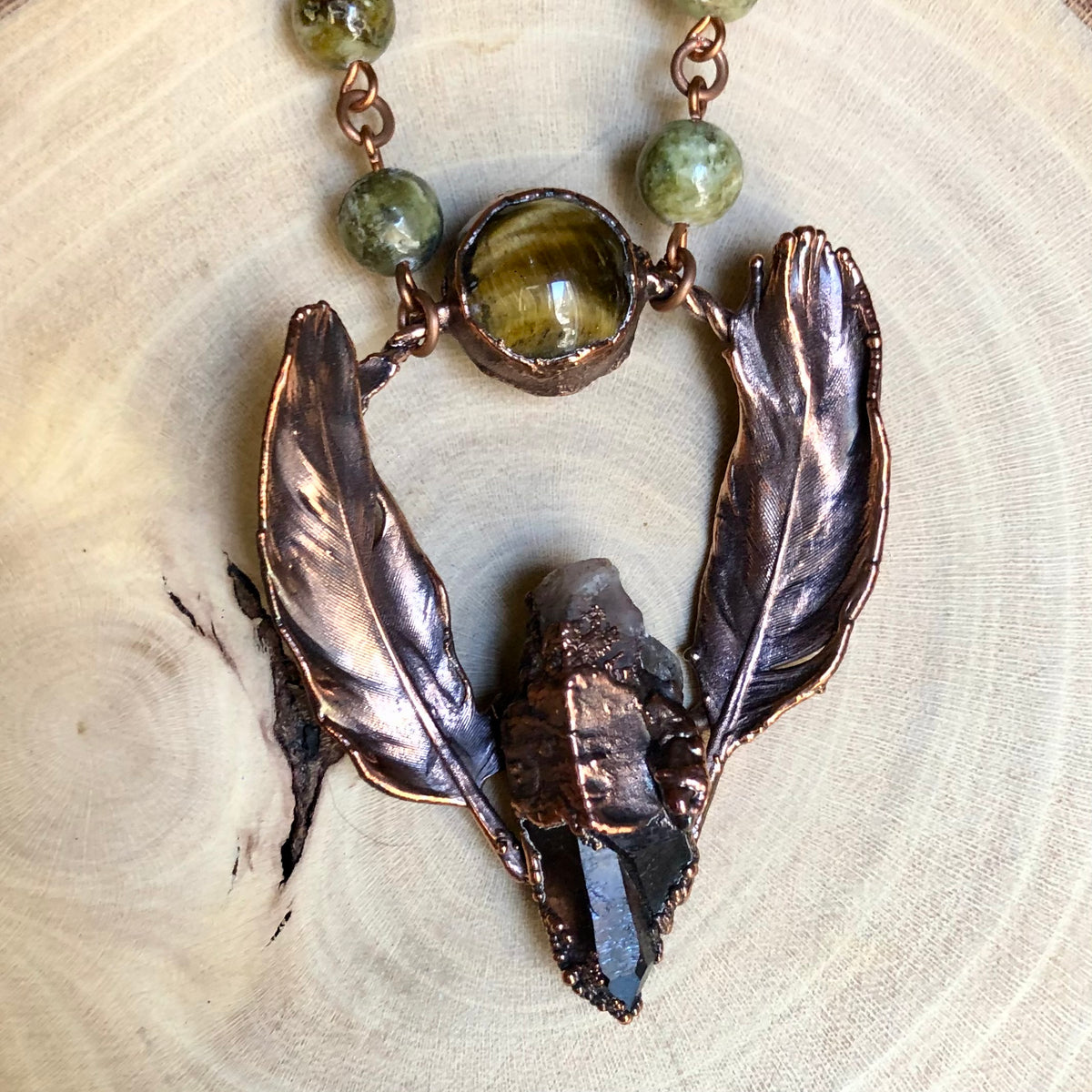 ST. CATHERINE’S SMOKY QUARTZ, TIGER EYE, GREEN GARNET & PIGEON FEATHERS