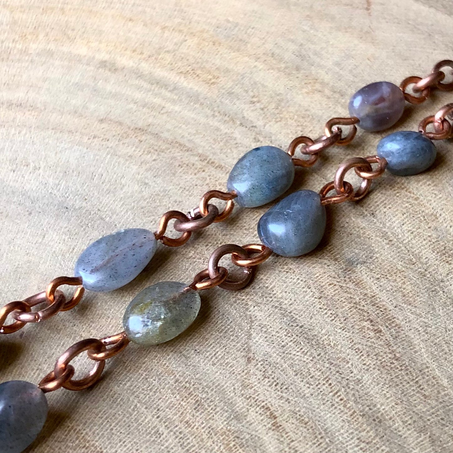 LABRADORITE ON PIGEON FEATHER